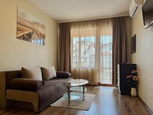 a living room with a couch and a table at Hotel Silver in Sozopol