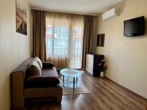 a living room with a couch and a glass table at Hotel Silver in Sozopol