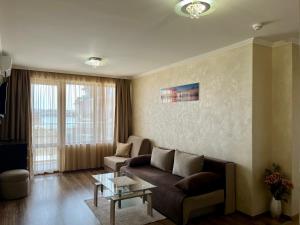 a living room with a couch and a table at Hotel Silver in Sozopol