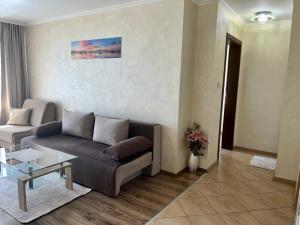 a living room with a couch and a table at Hotel Silver in Sozopol