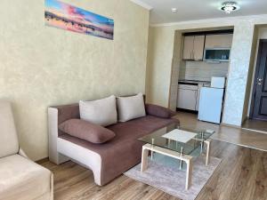 a living room with a couch and a table at Hotel Silver in Sozopol