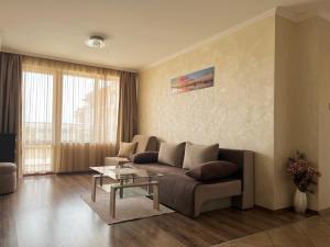 a living room with a couch and a table at Hotel Silver in Sozopol