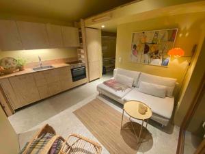 a living room with a couch and a kitchen at House by the ocean in Halmstad