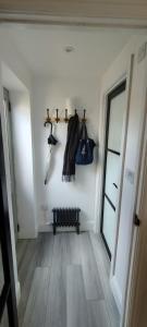 a hallway with coats and hangers on a wall at The Nook: Self Contained Annex in Taunton