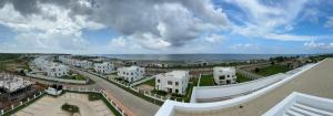 a view of a city with white buildings and the ocean at SEA VIEW LUXURIEST APARTMENT in Mazizini