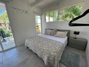 a bedroom with a bed and a large window at The Tulum Vibe in Old Town PV in Puerto Vallarta