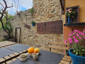 a table with fruit on it in front of a building at L Aparté en Corbières in Ferrals-lès-Corbières