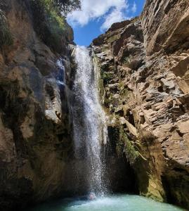 a waterfall on the side of a rocky mountain at Gite Ain Bechar in Taza