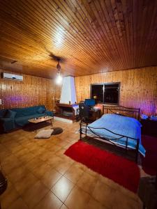 a bedroom with a bed and a desk in a room at Attic House in Patra