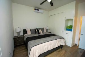 a bedroom with two beds and a ceiling fan at Residence 35 in Puerto Peñasco