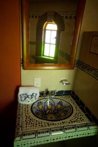 a bathroom with a sink and a mirror at Hotel Villas San Miguel in Pátzcuaro