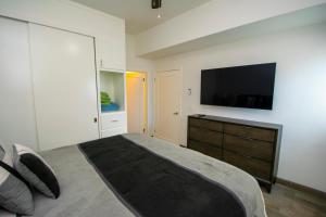 a bedroom with a bed and a television on a wall at Residence 35 in Puerto Peñasco