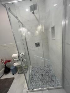a shower with a glass door in a bathroom at Private Suite In Huntington Station in Huntington Station