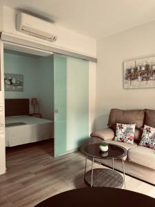 a living room with a couch and a table at calle mayor in Alcalá de Henares +9 photos