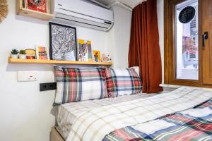 a small bedroom with a bed and a window at GALATA FİVE APARTMENTS in Istanbul