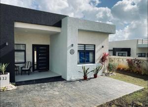 a modern house with a patio in front of it at Just like home Vacation in Ocho Rios