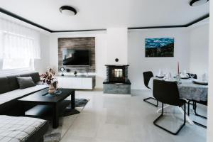 a living room with a couch and a table and a fireplace at Villa Tina in Velika