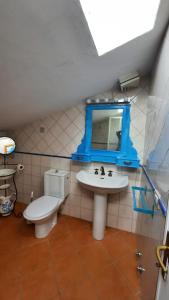 a bathroom with a toilet and a sink and a mirror at La Mansarda in Figline Valdarno
