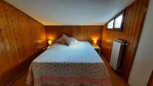 a bedroom with a bed in a wooden room at La Mansarda in Figline Valdarno