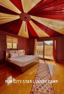 a bedroom with a bed with a red ceiling at Rum city Star LUXURY Camp in Wadi Rum