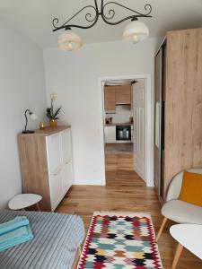 a living room with a couch and a rug at Apartament na Tatarskiej z widokiem in Przemyśl +7 photos