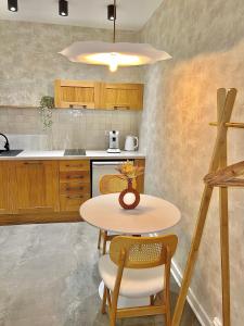 a kitchen with a table and two chairs and a table at Spa - Sauna privatif plein centre in Troyes