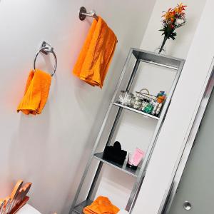 a ladder shelf in a room with orange towels at The Penthouse in Cincinnati