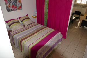 1 dormitorio con 1 cama con cortinas rosas en La Joliette, en Trois-Rivières