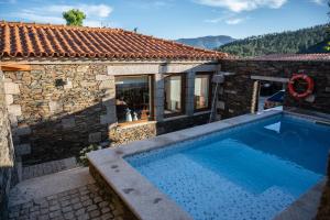 a house with a swimming pool next to a building at Casa da Ferreira_Vila Real in Vila Real