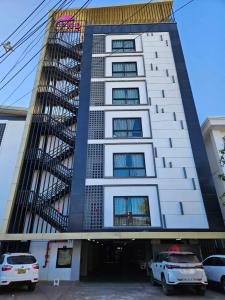 a building with cars parked in front of it at PND apartment 코너룸 한국식 콘도 in Vientiane