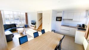 a kitchen and a living room with a table and chairs at Vakantiewoning Kaviaar in Middelkerke