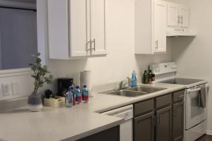 a kitchen with white cabinets and a sink at Welcoming 4BR near ISU in Ames