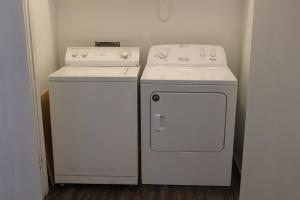two white appliances sitting next to each other in a kitchen at Welcoming 4BR near ISU in Ames