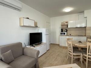a living room with a couch and a kitchen with a table at HORIZON 12 'A' APARTMENT Sveti Vlas in Sveti Vlas +46 photos