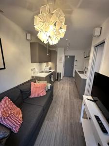 a living room with a couch and a kitchen at Modern Flat in Camden Town in London