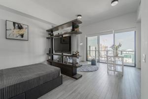 a bedroom with a bed and a television and a balcony at TR Miami 2 Bedroom Condo and Studio with Balcony in Miami
