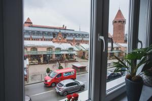 a view of a city street from a window at Gdańsk ONE in Gdańsk