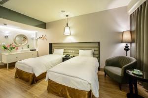 Säng eller sängar i ett rum på Stay Hotel - Taichung Yizhong