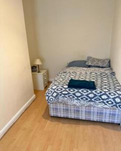 a small bedroom with a bed and a night stand at Mortiara in Darlington