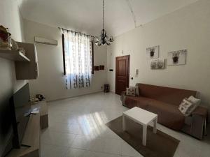 a living room with a couch and a table at Il Vigneto in Trapani +11 photos