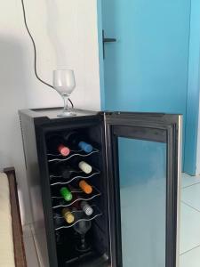 a wine cooler with a wine glass on top of it at Casinha Estrela do Mar o Oceano aos seus Pés in Aracati