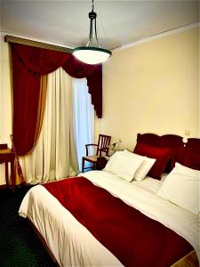 a bedroom with a large bed with a red blanket at GLARENTZA in Kyllini