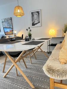 a living room with a table and a couch at Living at Saarpartments -AdultsOnly- 2 Bedrooms, Kitchen- Business & Holiday Apartments for Long- and Short term Stay, 3 min to Train-Station, Secure E-Bike Parking! in Saarbrücken