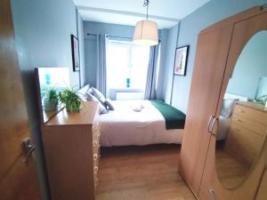 a bedroom with a bed and a large window at Central London rooms EC1V in London