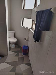 a small bathroom with a toilet and a window at Departamento Trébol in Sucre
