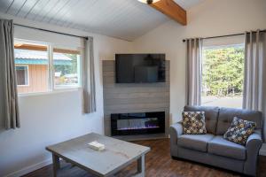 a living room with a couch and a tv at Manning Park Resort in Manning Park