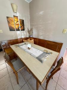 a dining room with a wooden table and chairs at Casa Tilo in El Bolsón