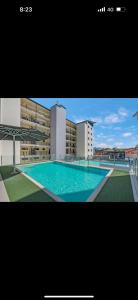 a large swimming pool in front of a building at 5 minute walk to the Stadium!! Taylord Holiday Homes and Apartments in Townsville