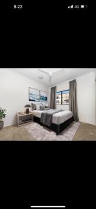 a bedroom with two beds and a large window at 5 minute walk to the Stadium!! Taylord Holiday Homes and Apartments in Townsville