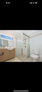a bathroom with a shower and a sink and a toilet at 5 minute walk to the Stadium!! Taylord Holiday Homes and Apartments in Townsville